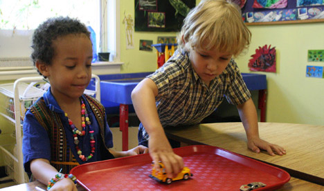 Photo of two children playing together in a class