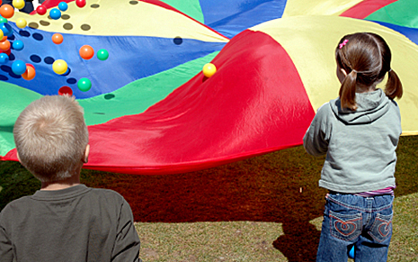 children playing with parachute