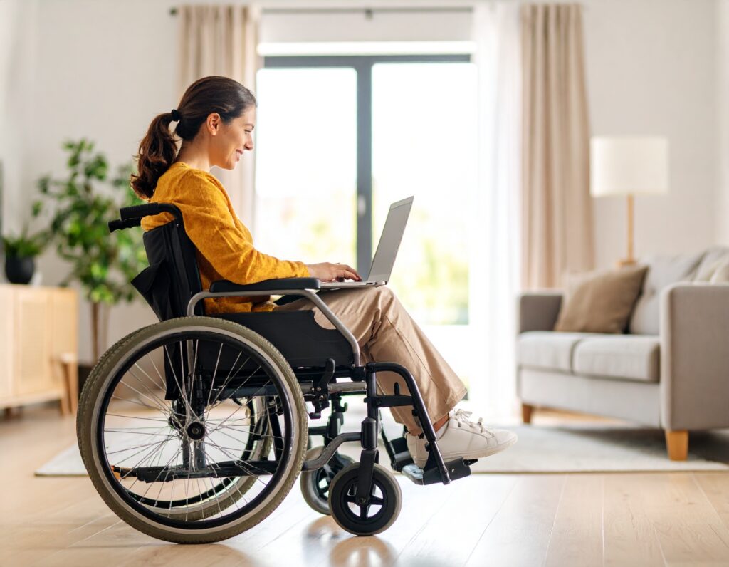 Person in a wheelchair using a laptop