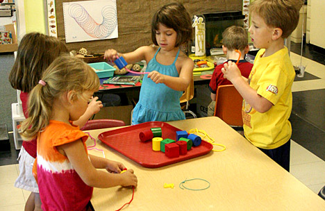 photo of children making bead necklasses