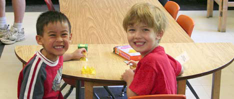 photo of two children doing puzzles in a classroom