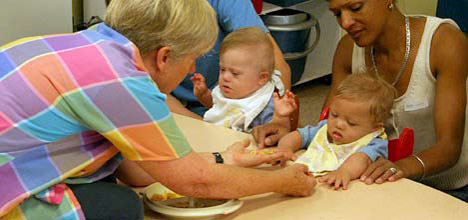 photo of child being given a choice between foods