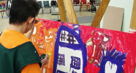 boy painting at easel