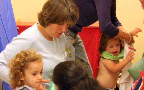 photo of child getting dressed at daycare