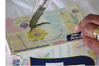 photo of cutting the box to insert the paper towl roll