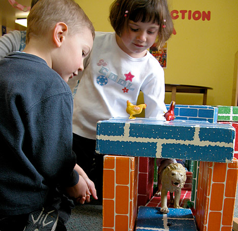photo of two children playing together in a classroom
